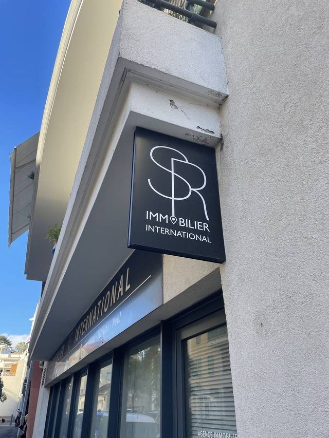 Enseigne & signalétique — SPR Immobilier International : enseigne drapeau caisson agence immobiliere